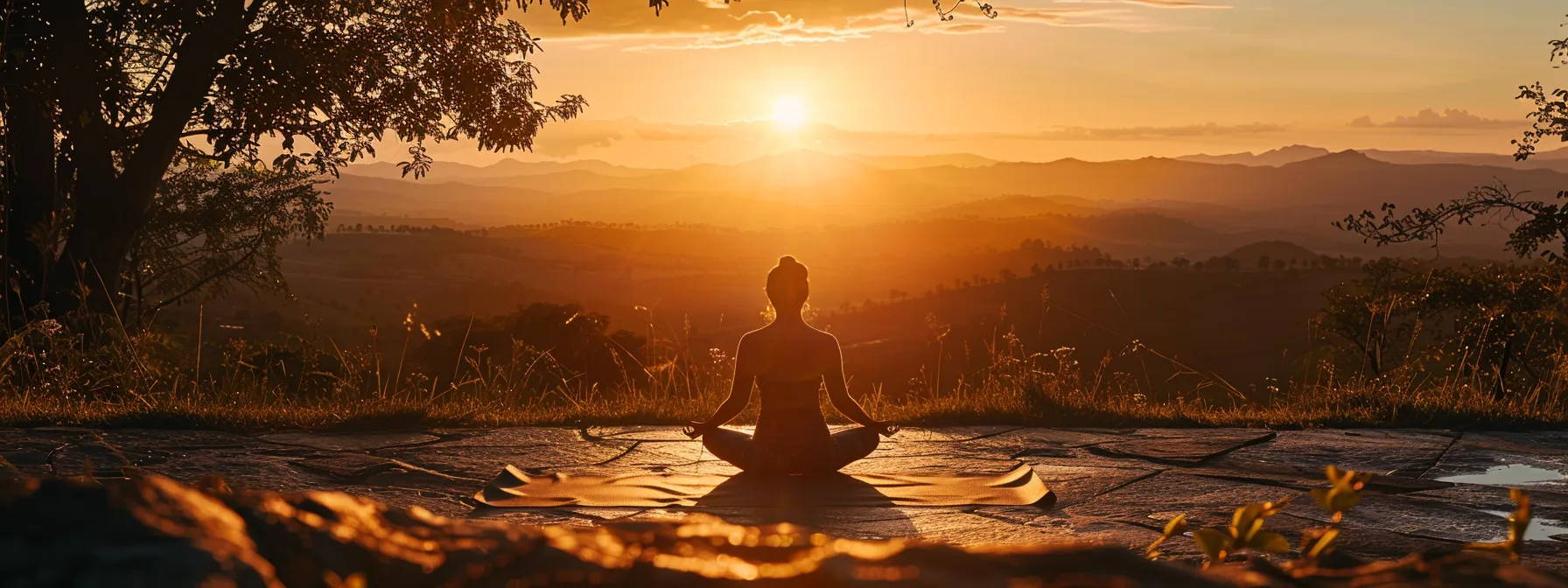 a serene yoga session at sunrise, where an individual gracefully flows through poses amidst a tranquil landscape, embodying the essence of mindfulness and personal growth.