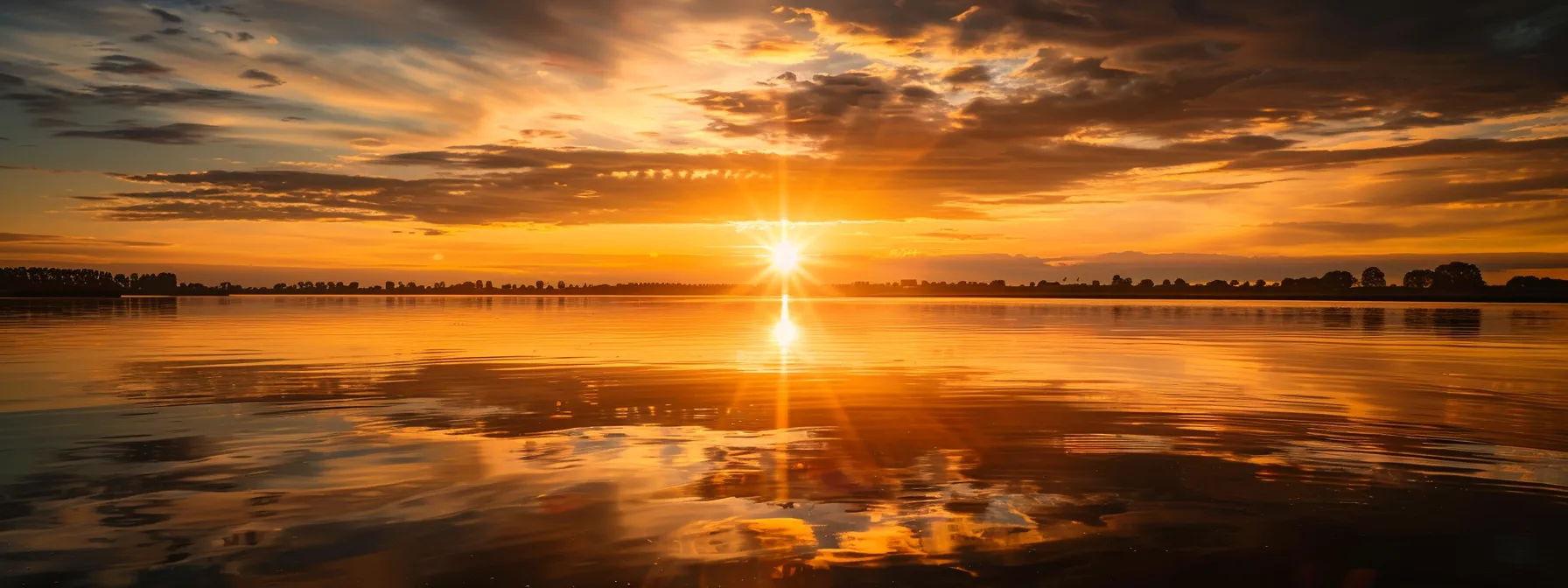 a vibrant sunset casts a warm golden glow over a serene lake, reflecting the brilliant hues of orange and pink in a tranquil atmosphere.